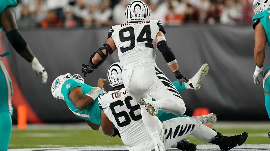 Tua is tackled by the Bengals defender